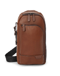 This TUMI Harrison Gregory Sling Bag Cognac Leather has a front zip pocket.