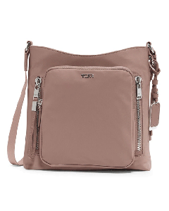 TUMI's Voyageur Mauve Tyler Crossbody Bag has polished silver hardware with the TUMI branding on the front.